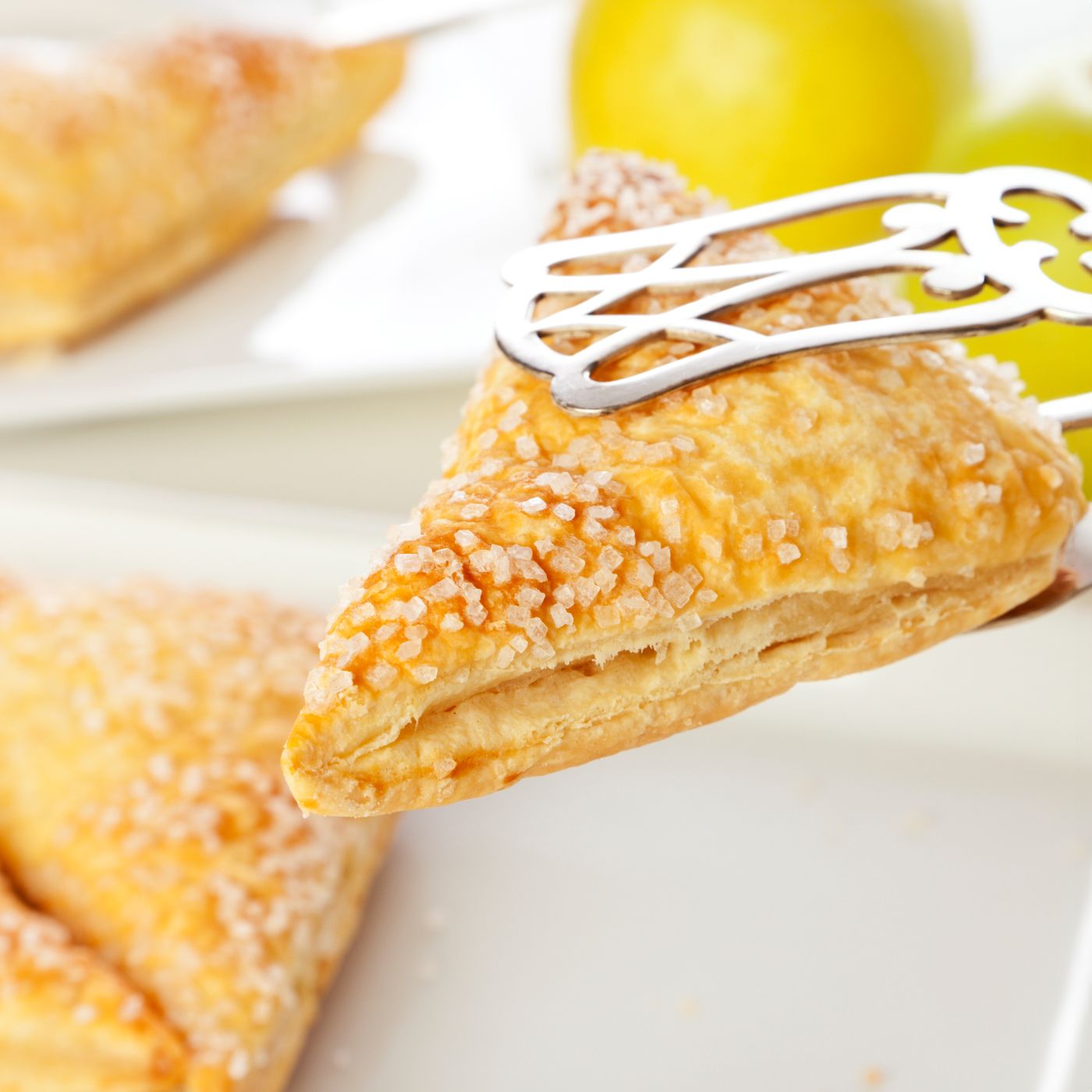 Pastry-tongs-holding-apple-turnover-178575724_3866x2578 square.jpeg