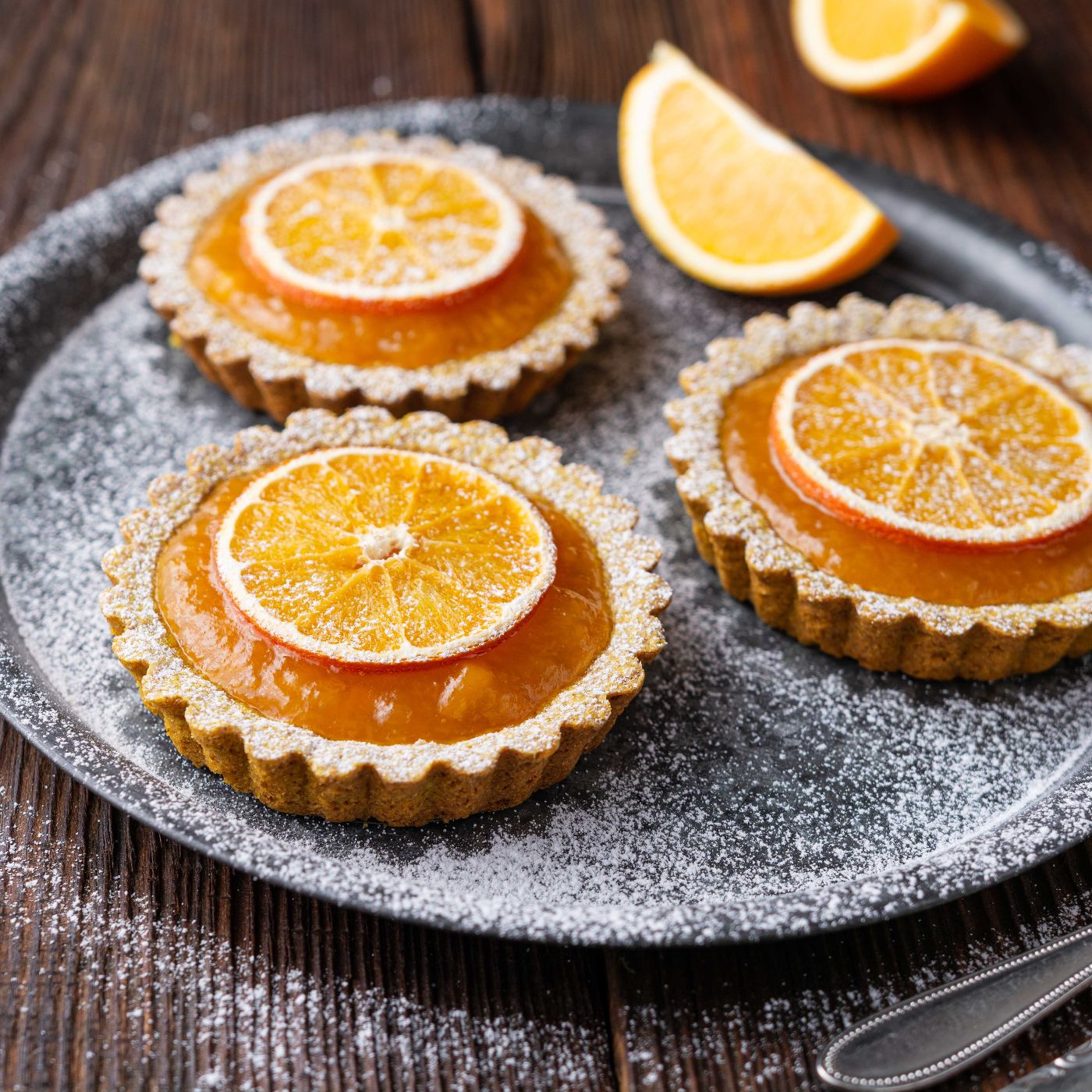 Whole-wheat-turmeric-tartlets-filled-with-apricot-jam,-decorated-with-dried-oranges,-topped-with-powdered-sugar-1194762437_6000x4000 aquare.jpeg