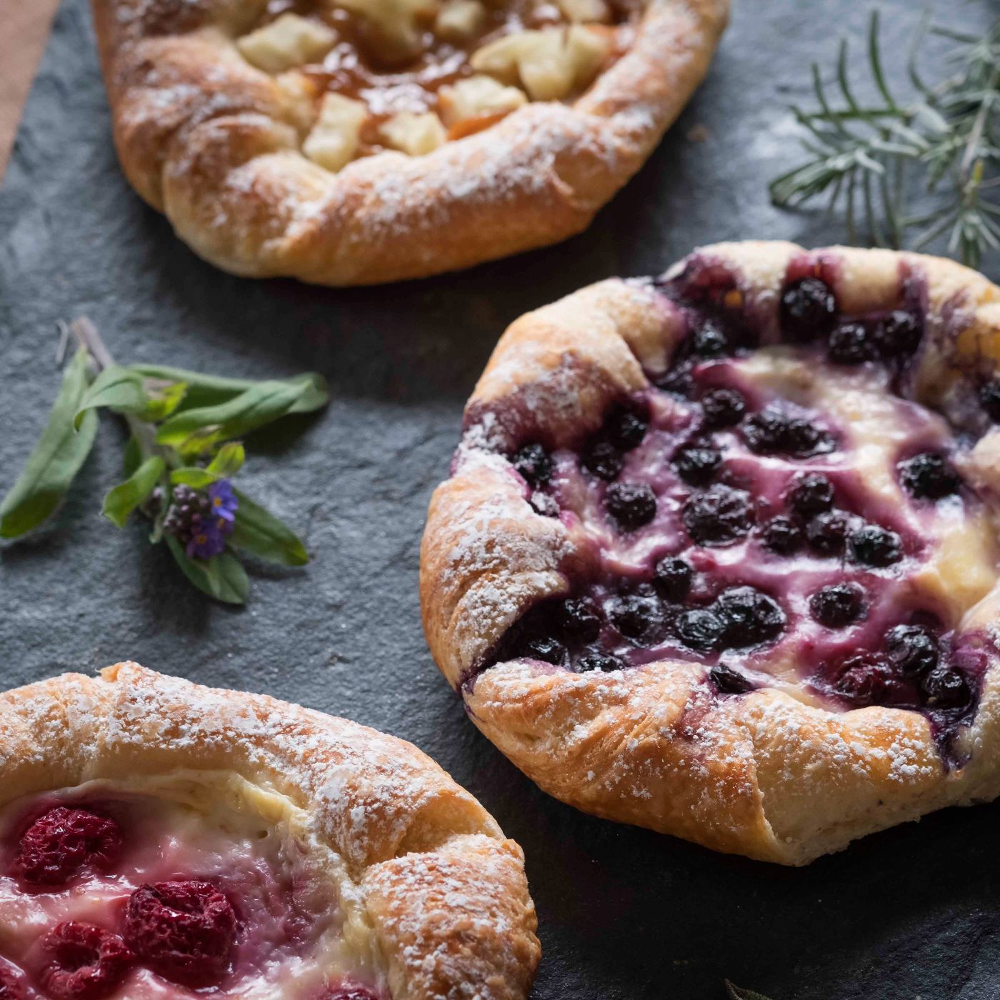 Rustic-Apple,-Blueberry-and-Raspberry-Custard-Danishes-on-Slate-Platter-1395084907_6000x4000 square.jpg