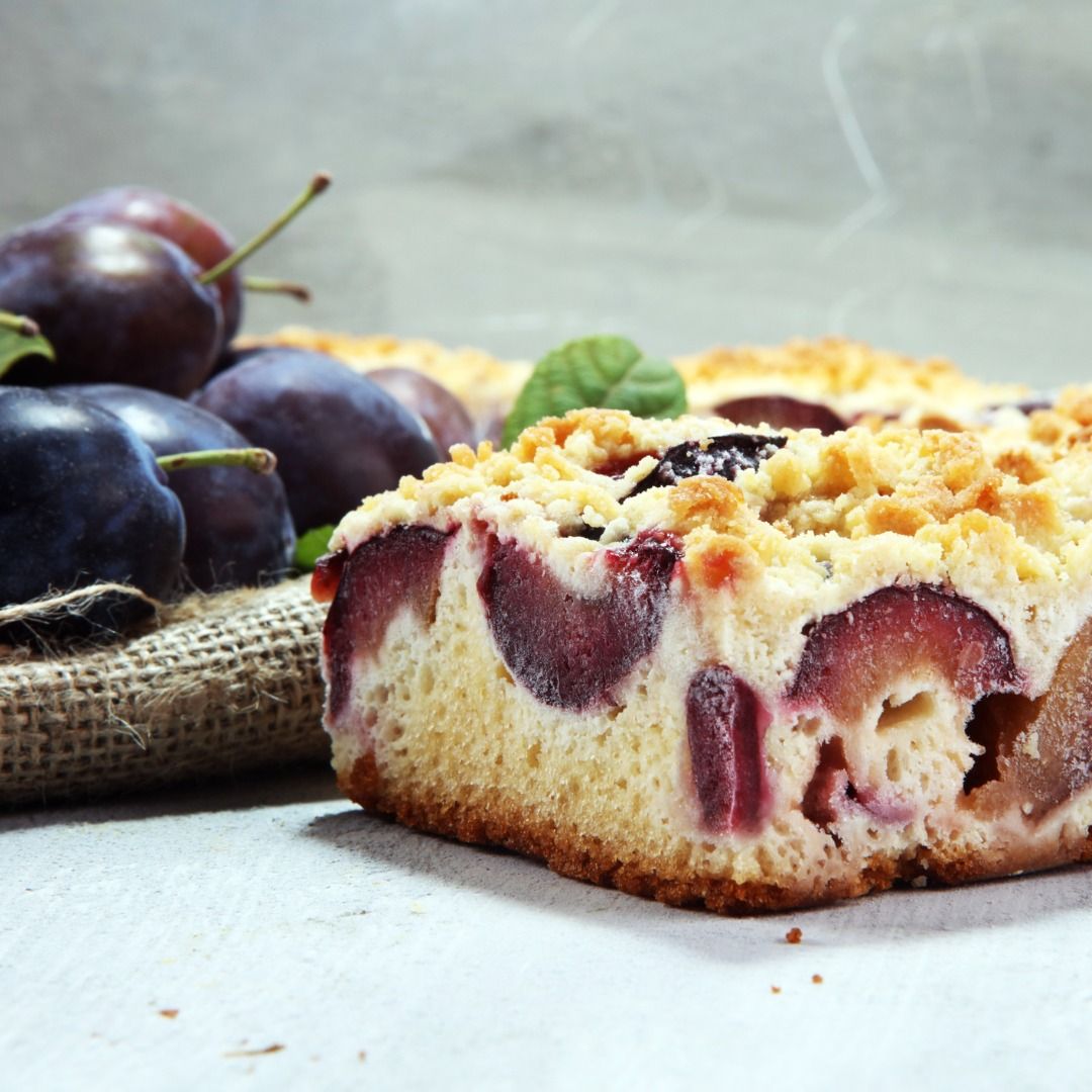 rustic-plum-cake-on-wooden-background-with-plums-around-picture-id1015585346.jpg
