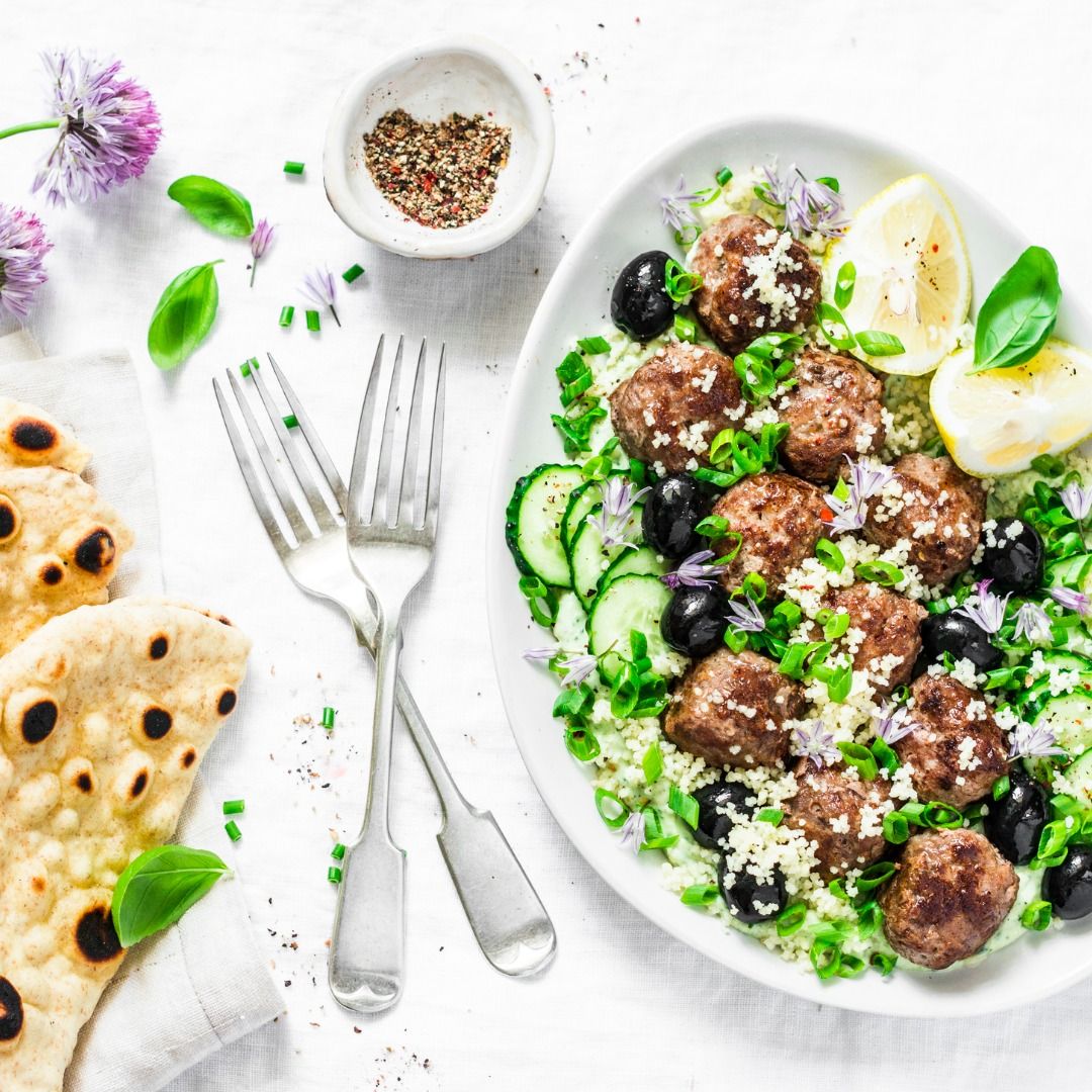 greek-lamb-meatballs-with-avocado-greek-yogurt-sauce-couscous-and-picture-id974916912.jpg