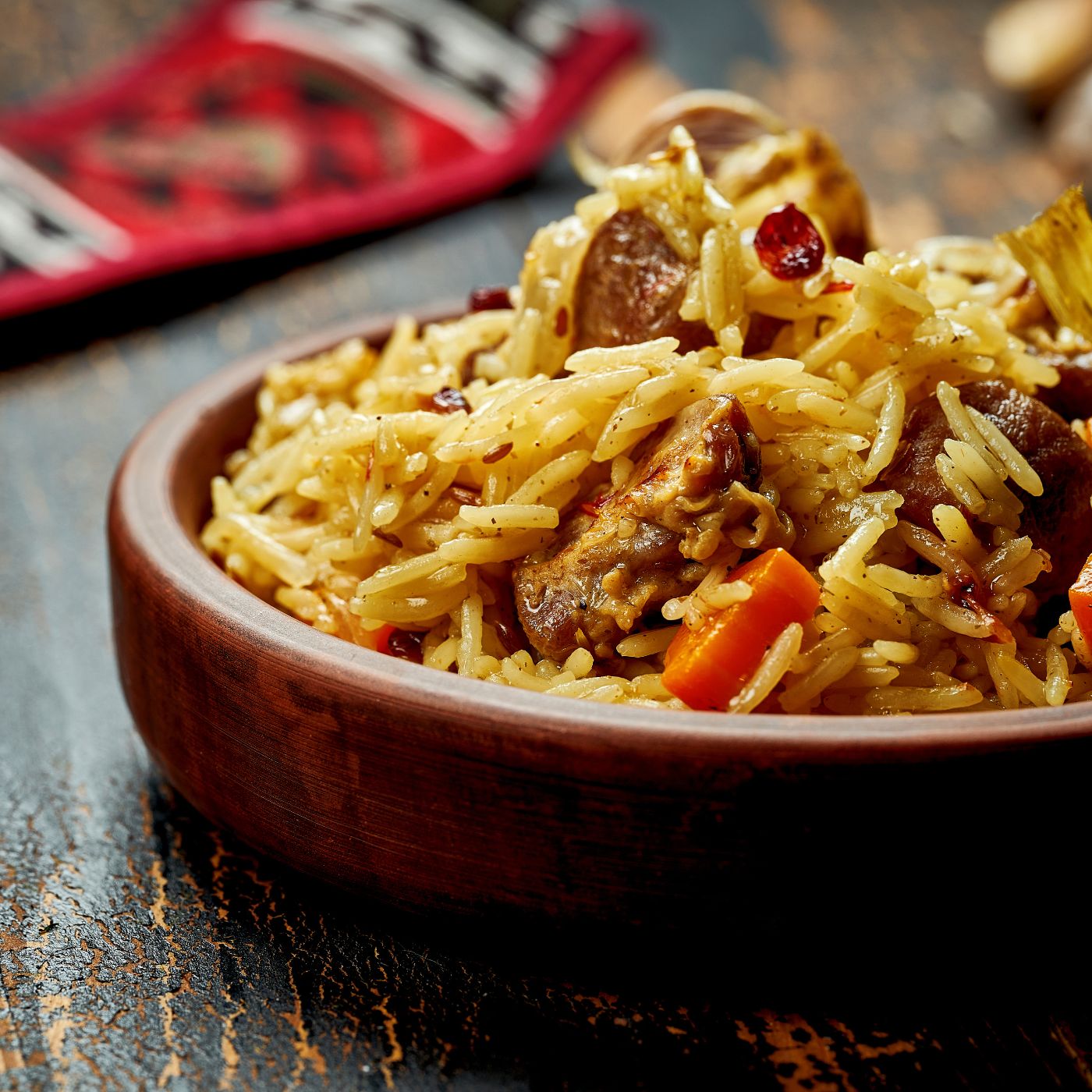 Classic-pilaf-with-beef,-garlic-and-carrots-in-a-clay-plate-on-a-wooden-background.-Rustic-1475006864_3869x2579 square.jpeg
