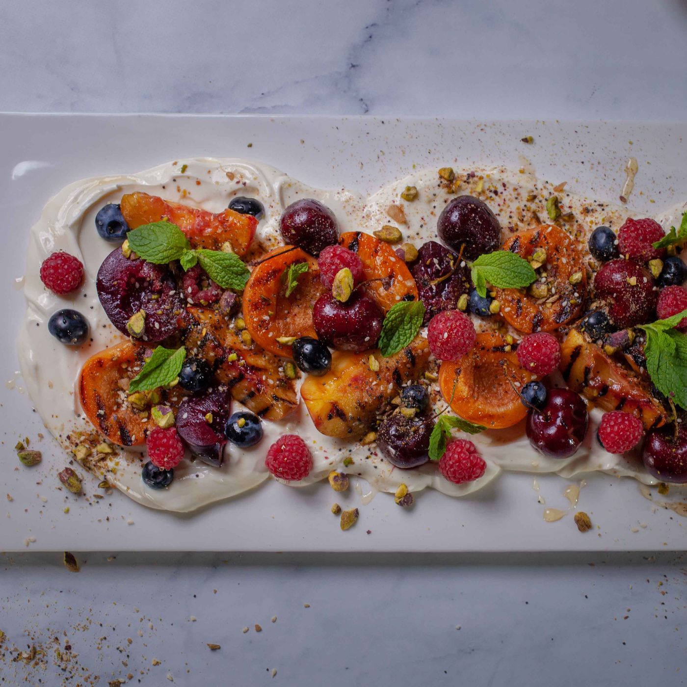 Grilled fruit with honey labneh and pistachio dukkah