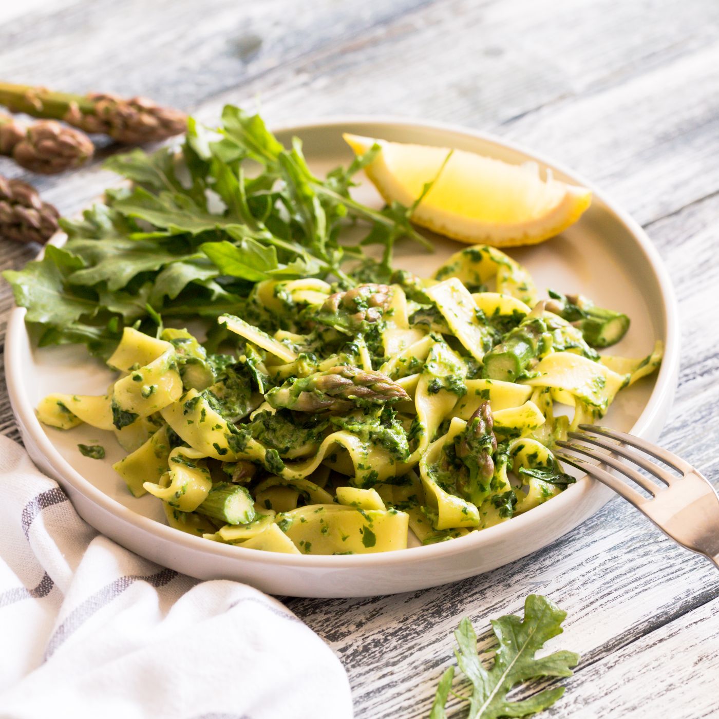 Fresh-homemade-tagliatelle-with-spinach-and-asparagus.-pasta-with-cream-sauce-and-vegetables-1279365070_5472x3648 square.jpeg