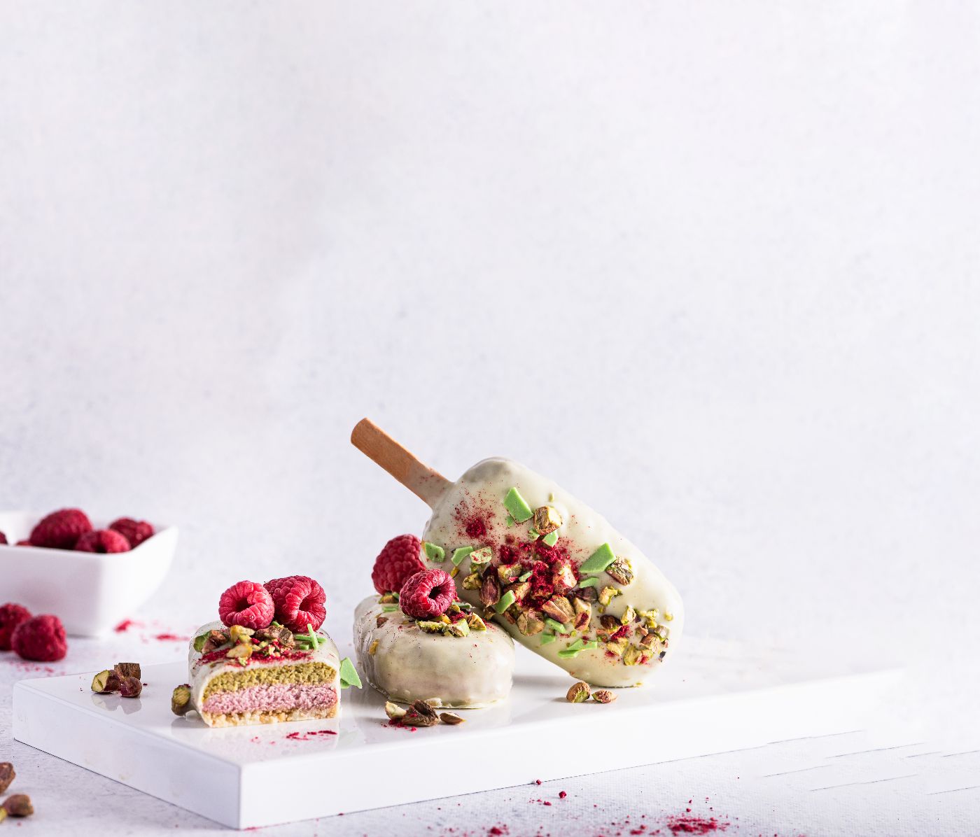 Ice-cream-sticks-with-white-chocolate,-fruit,-pistachios-and-colored-sugar-on-a-white-background.-1299642877_4378x3502 a3.jpg
