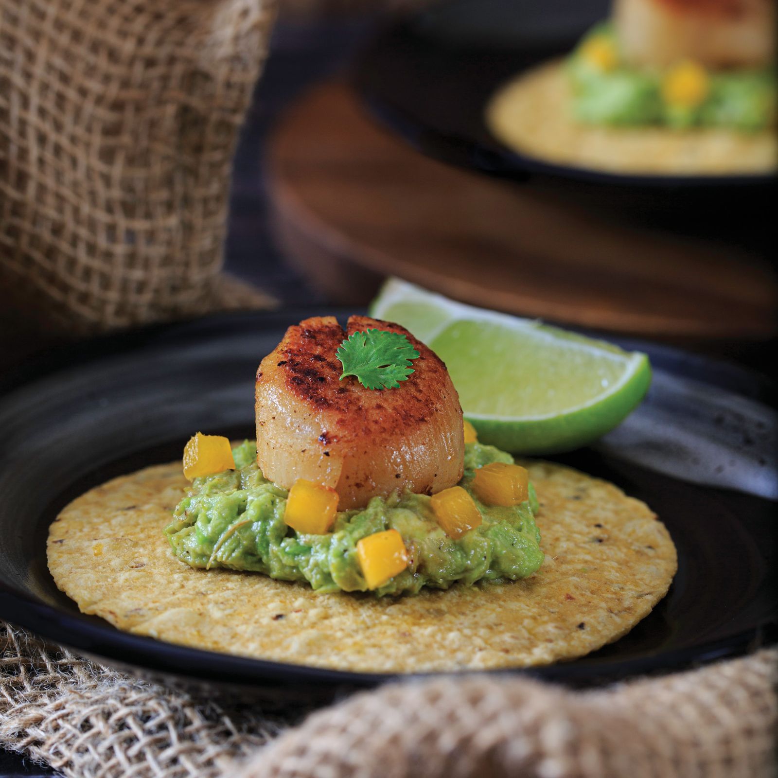 Seared scallops with mint, peas and bacon