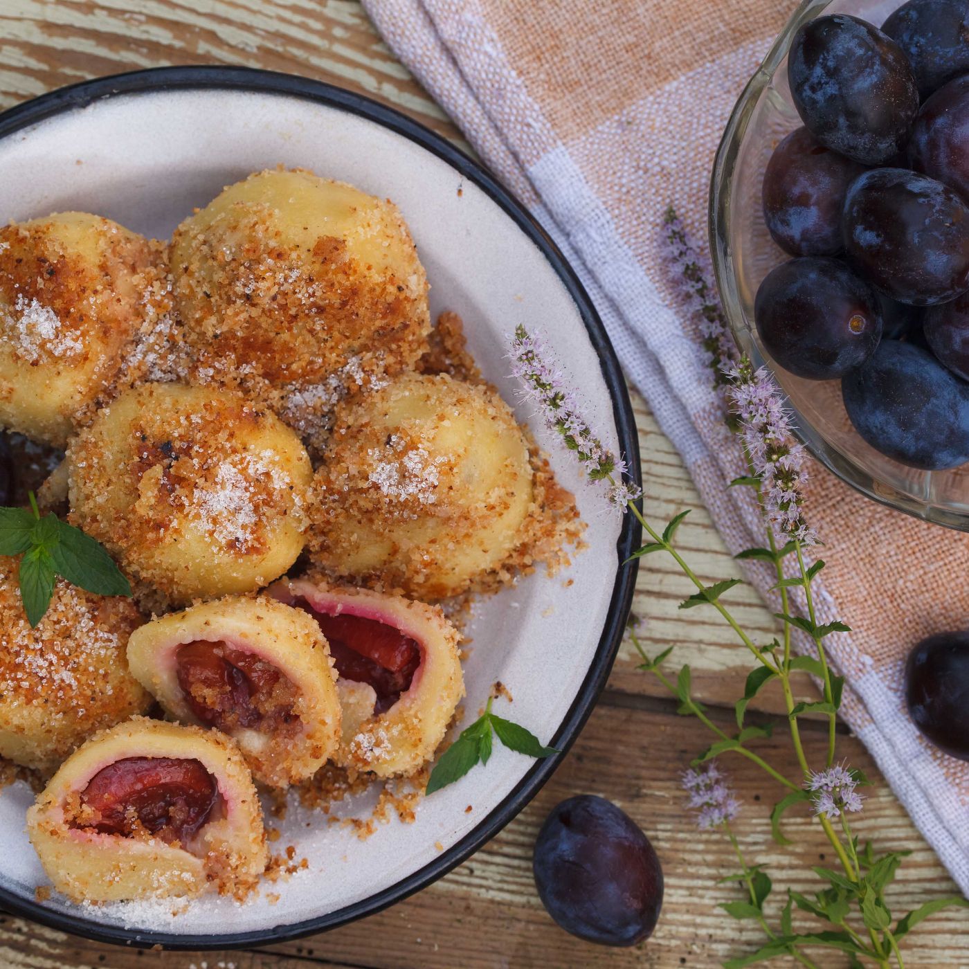 Sweet-plum-dumplings-in-metal-bowl-on-wooden-table-1006225460_5616x3744 square.jpeg