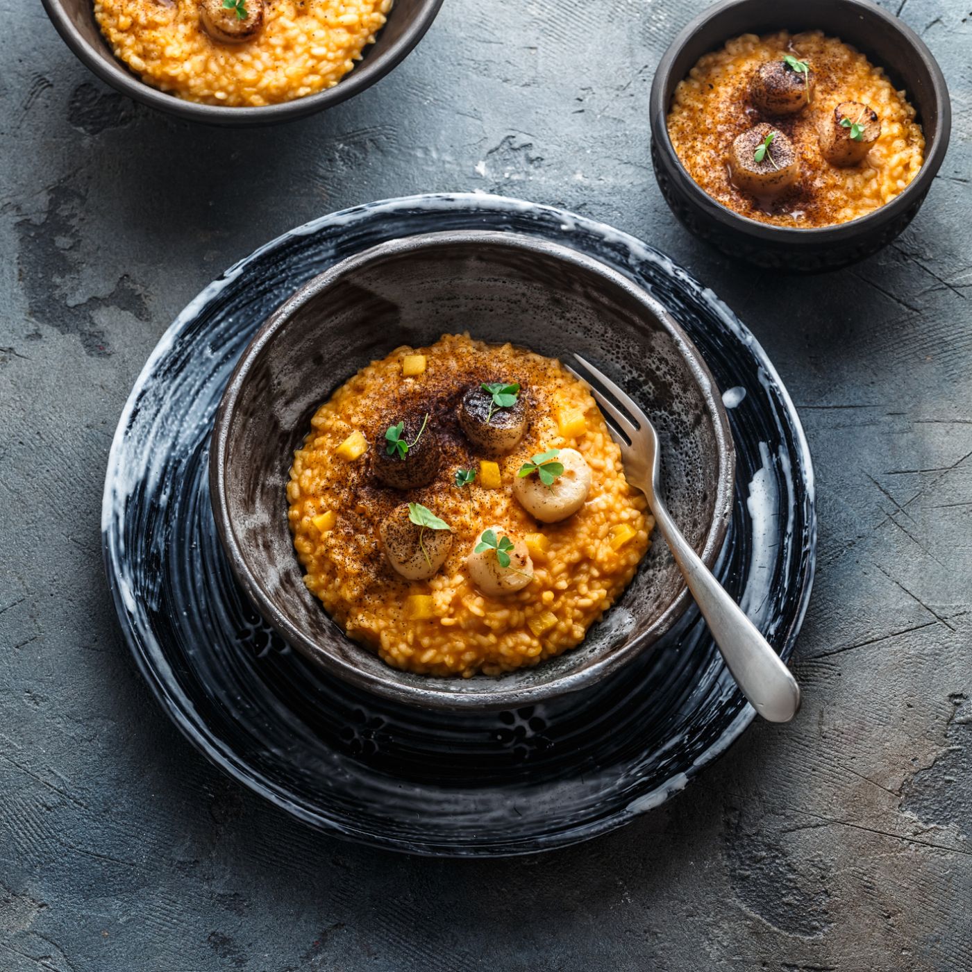 Risotto-with-pumpkin-and-scallops,-on-stone-background,-copy-space-1179223472_2125x1416 square.jpeg