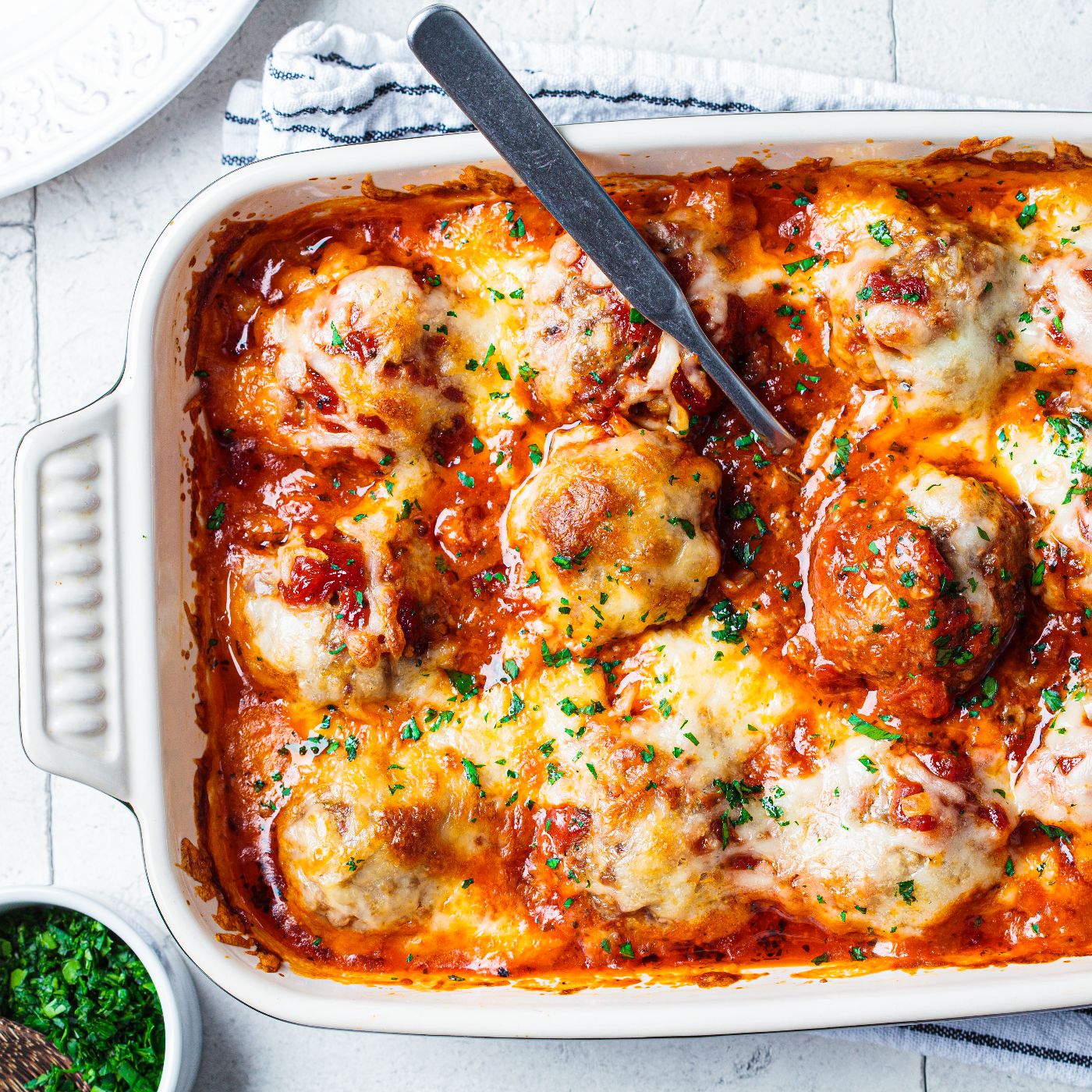 Baked-cheesy-meatballs-casserole-with-tomato-sauce-in-the-oven-dish,-top-view.-1316223694_5611x3741 square.jpeg