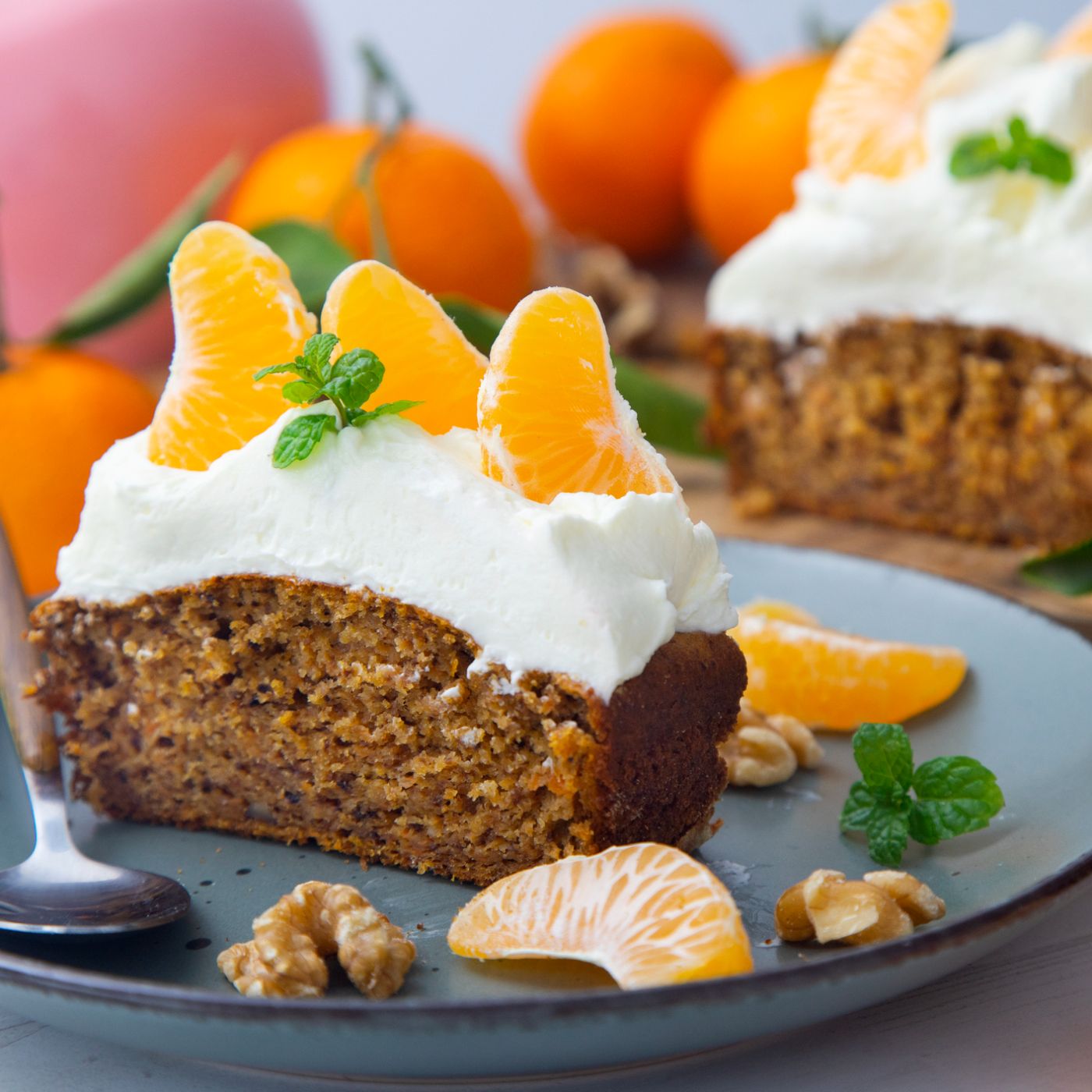 Vegan-tangerine-sponge-cake-with-a-giant-frosting-and-mandarin-orange-wedges-on-a-wooden-board.-1358280590_2125x1416 square.jpg