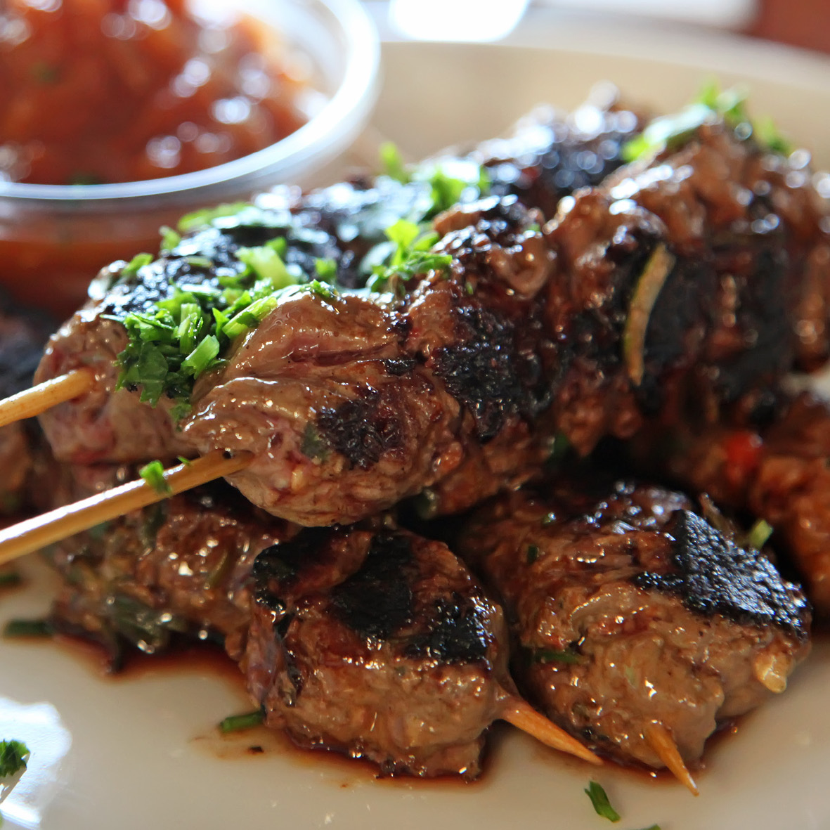 Beef skewer, mustard dressing and fried rosemary