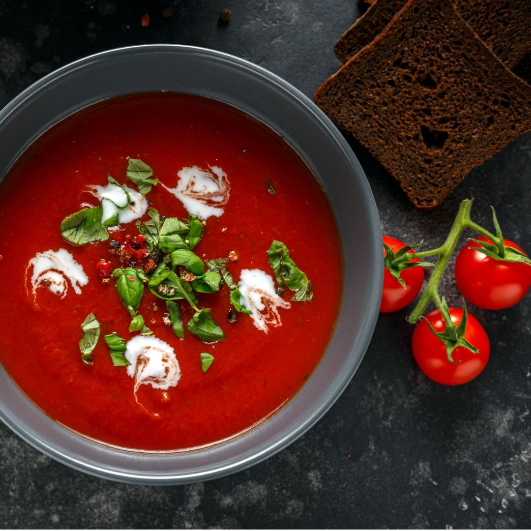 tomato-and-fresh-basil-soup-with-garlic-cracked-papper-corns-served-picture-id995320060.jpg